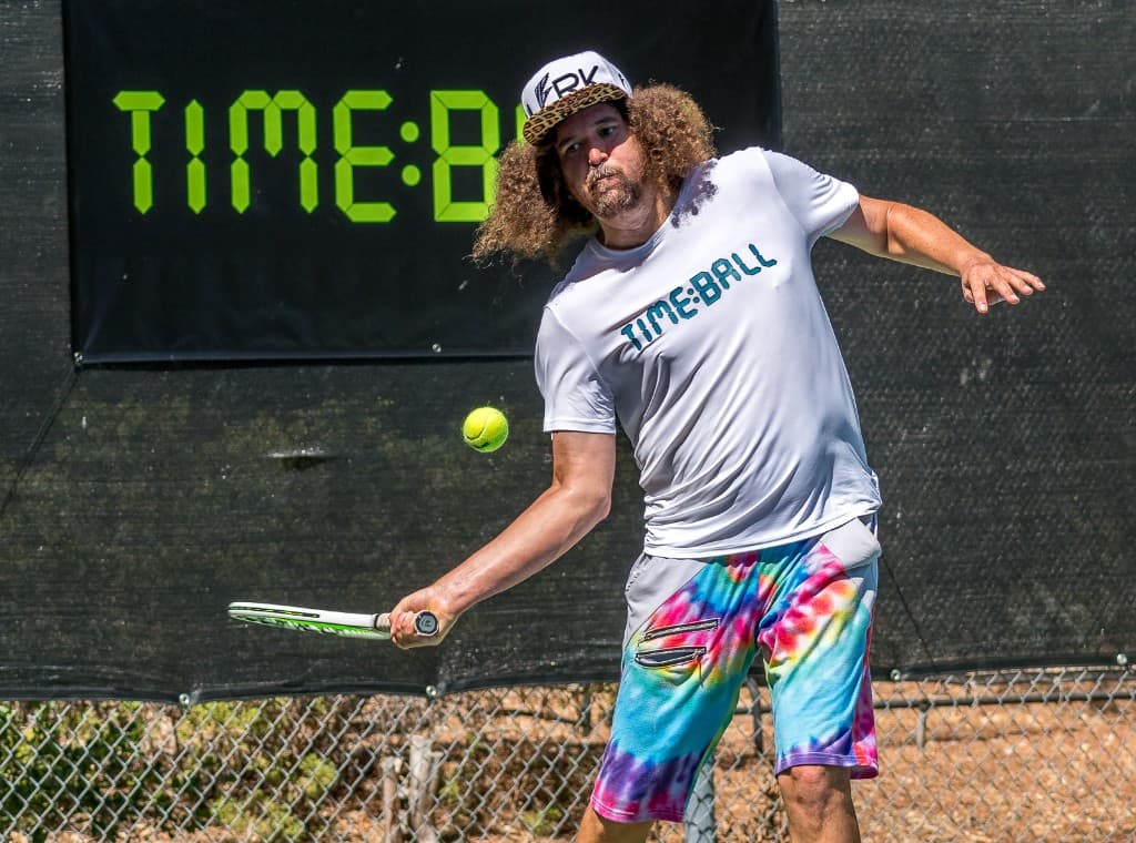 Timeball player hitting on court with TIME:BALL branding